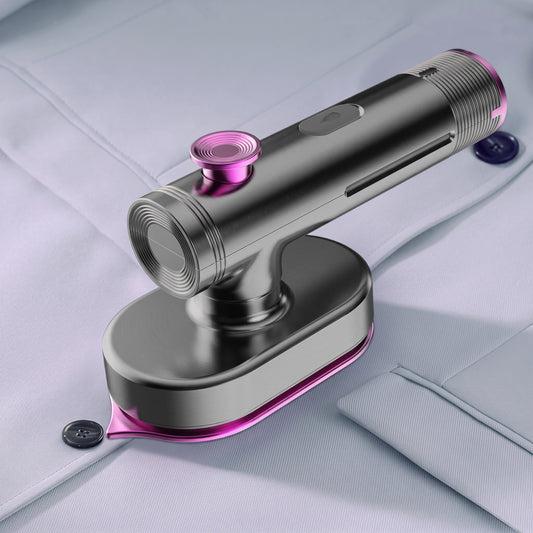 A handheld garment steamer with a metallic silver body and vibrant pink accents, shown steaming a light-colored dress shirt.